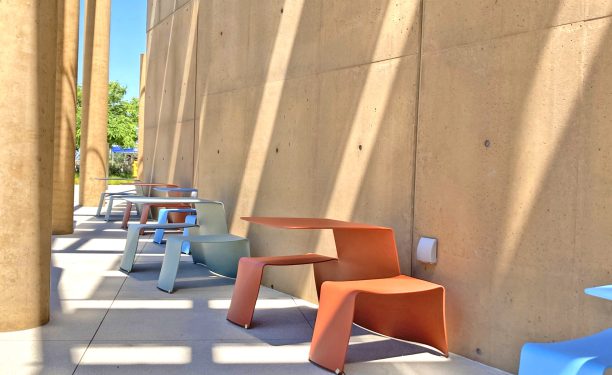 vibrantly colored chairs and tables on the side of first floor patio